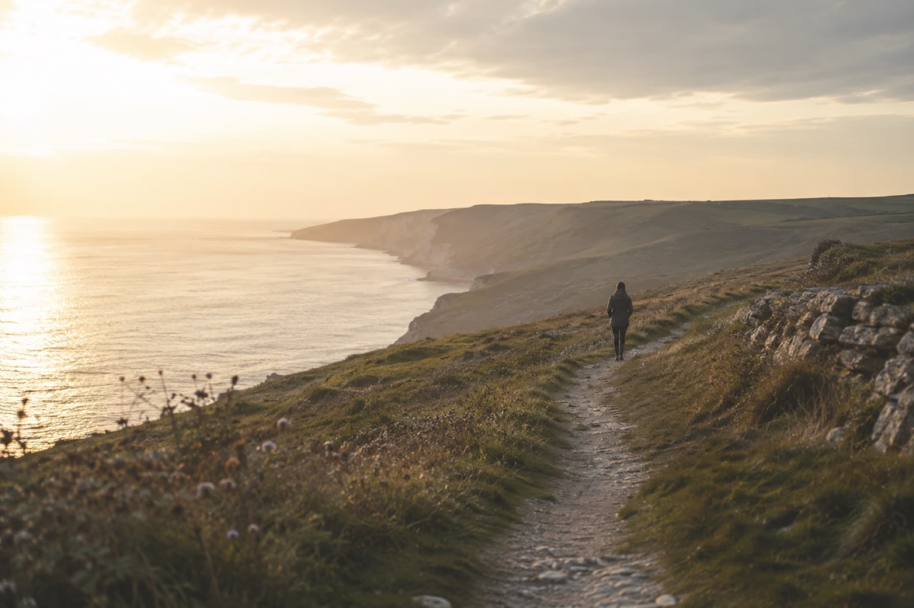 A person following a coastal path as recovery continues after treatment